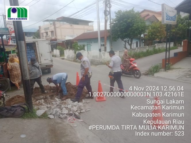 
 Petugas PDAM Tirta Mulia Karimun saat melakukan perbaikan saluran pipa yang tersumbat di depan Taruko Pelipit